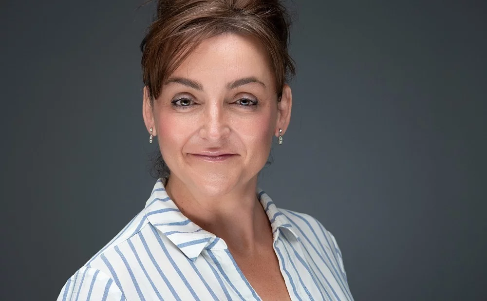 Caucasian female looking intently into the camera for corporate headshot