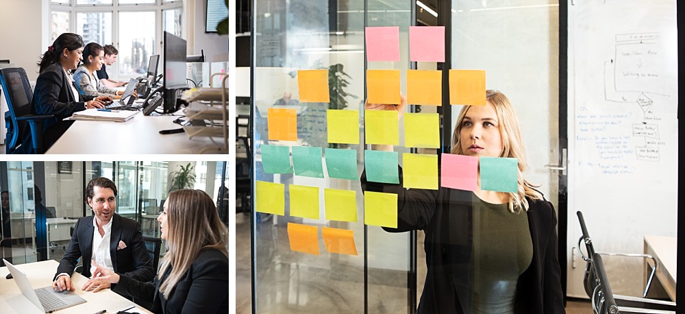 Staff working at computers, woman writing on sticky notes on glass wall
