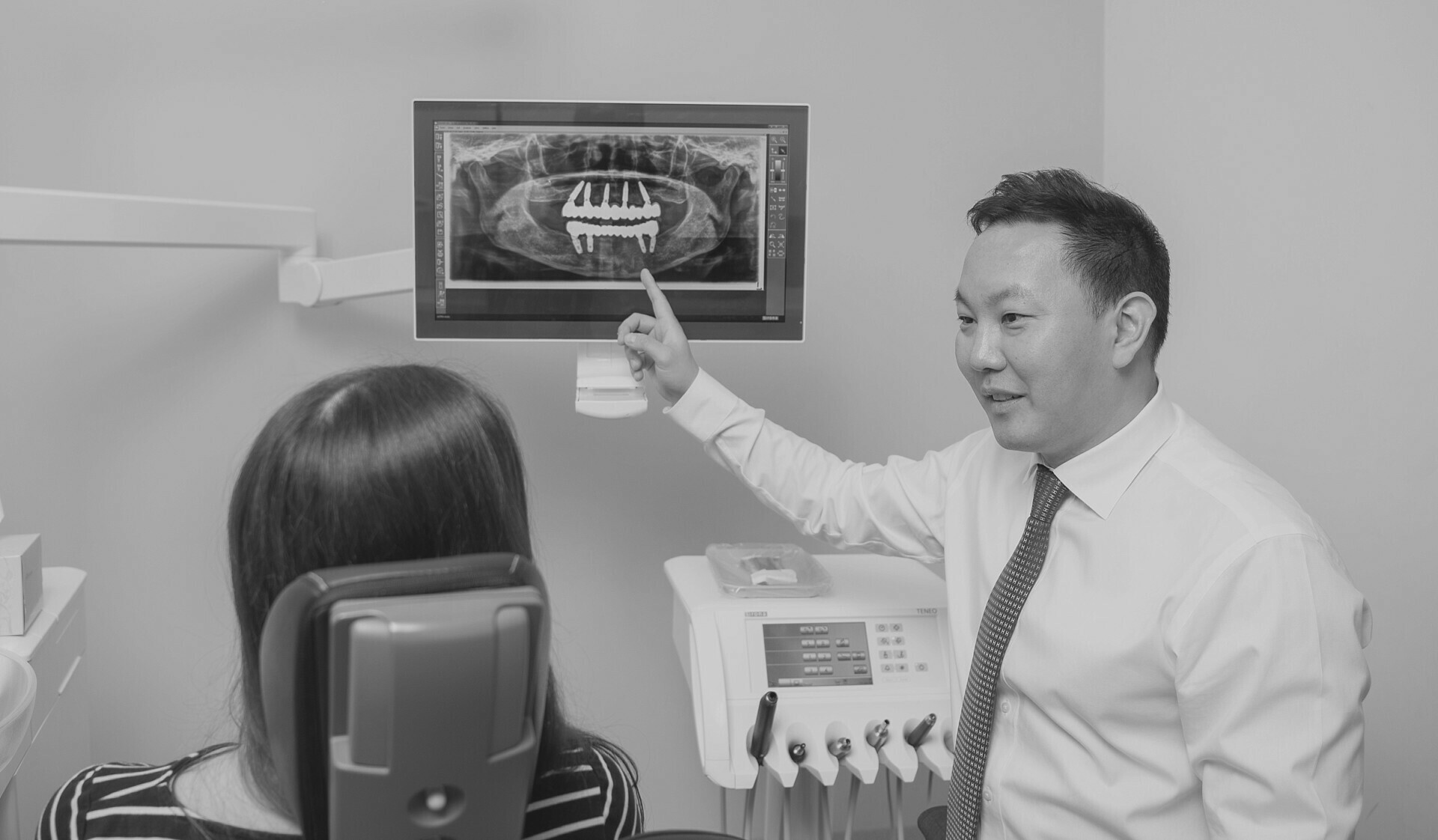 Dentist showing xray to patient